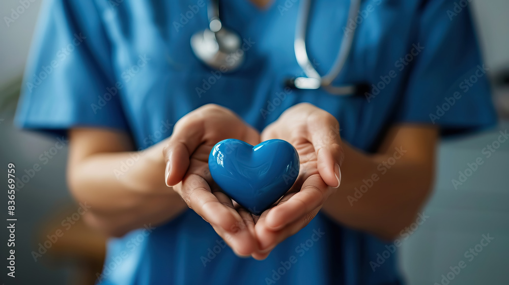 close up blue heart in nurse or doctor hand.