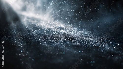 A detailed shot of dust particles illuminated by a beam of light in a dark room photo