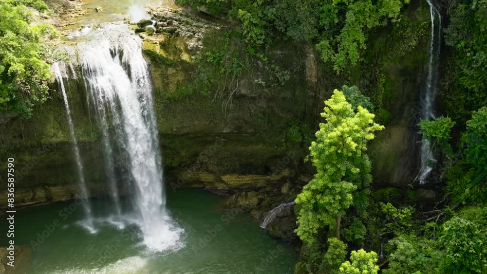 Beautiful waterfall in green forest. Ben-Ben Falls in mountain jungle Negros, Philippines. Beautiful waterfall in green forest. Ben-Ben Falls in mountain jungle Negros, Philippines.