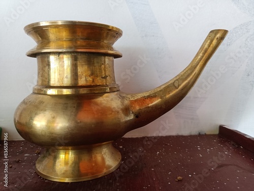 Golden Brass Kindi Water Pot With A Curved Spout photo