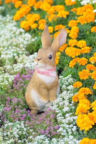 Statue of rabbits in summer flower background
