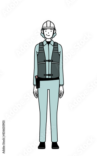 Senior female engineer in helmet and work wear with a smile facing forward