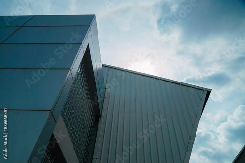 A building with a roof that is slanted and has a lot of windows