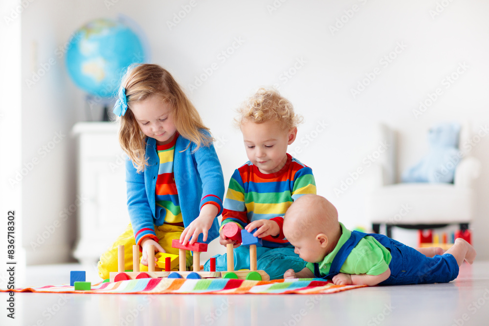 Fototapeta premium Kids playing with wooden toy train