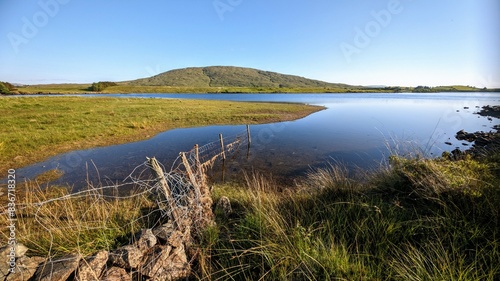 Obraz na płótnie Landscape scenery, lake and green mountain in background at Connemara national park, Galway, Ireland, wallpaper w salonie