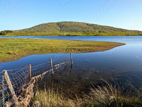 Obraz na płótnie Landscape scenery, lake and green mountain in background at Connemara national park, Galway, Ireland, wallpaper w salonie