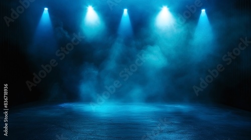 Empty stage with four blue spotlights and smoke, creating a dramatic and atmospheric ambiance.