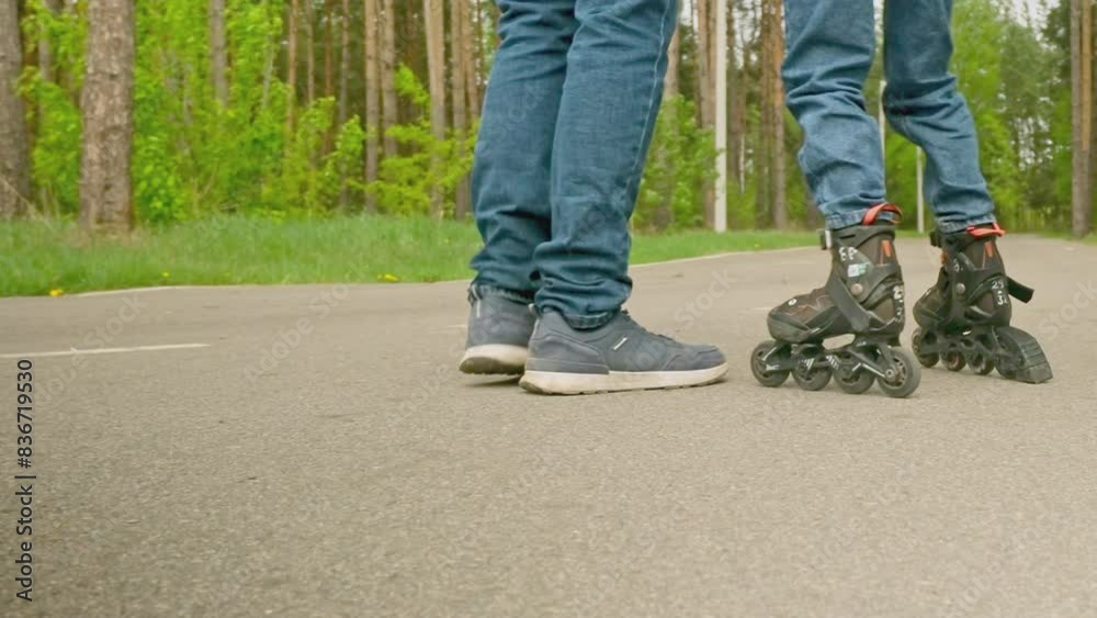 Father and daughter learn to roller skate outdoors. Father's Day. Father and daughter learn to roller skate outdoors. Father's Day.