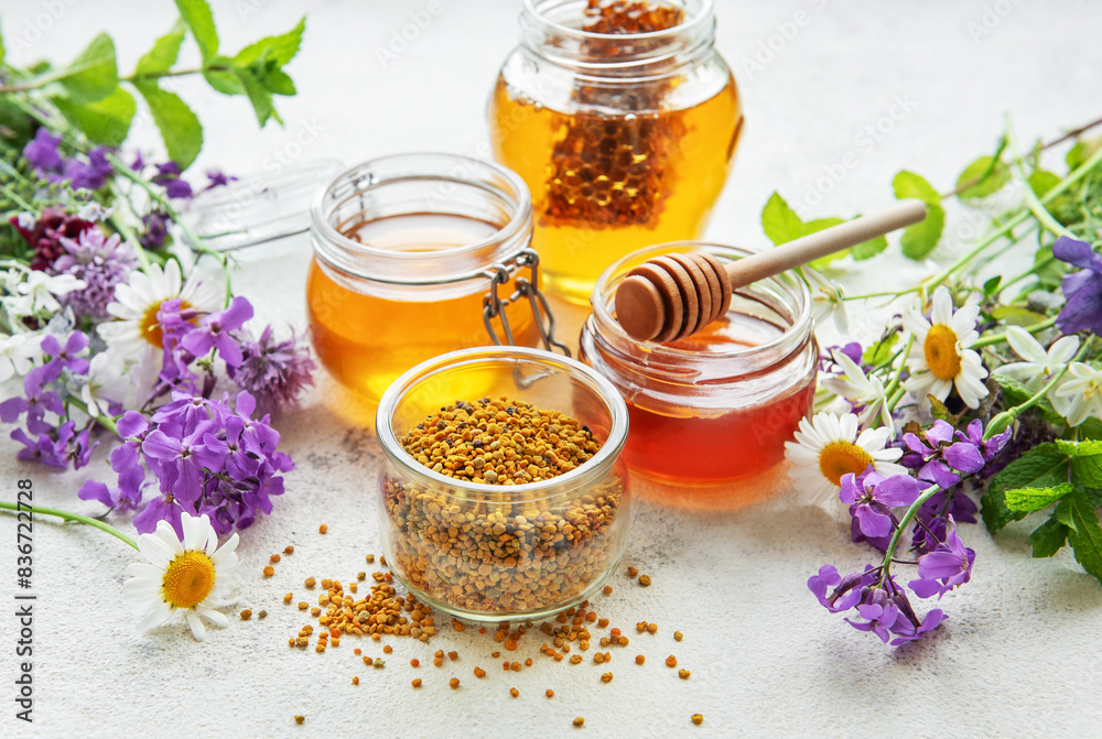 Raw organic bee pollen and honey in jars. Raw organic bee pollen and honey in jars.