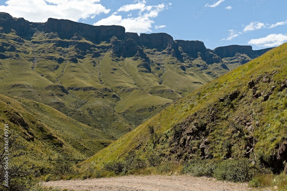 Driving view from Sani Pass (2,876 meters) to the rock formations of the Twelve Apostles in the Drakensberg Mountains and the landscape of KwaZulu-Nathal province. Republic of South Africa. Africa.