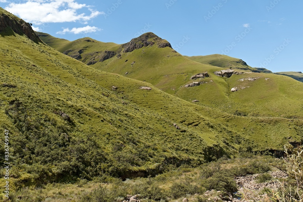 View while driving from Sani Pass (2,876 meters) to the Drakensberg mountain range and the countryside of KwaZulu-Nathal province. Republic of South Africa. Africa. View while driving from Sani Pass (2,876 meters) to the Drakensberg mountain range and the countryside of KwaZulu-Nathal province. Republic of South Africa. Africa.