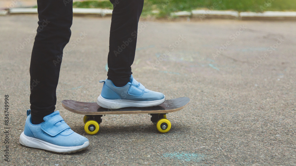 Pretty little girl learning to skateboard on beautiful summer day in a school yard. Child enjoying skateboarding ride outdoors. Pretty little girl learning to skateboard on beautiful summer day in a school yard. Child enjoying skateboarding ride outdoors.
