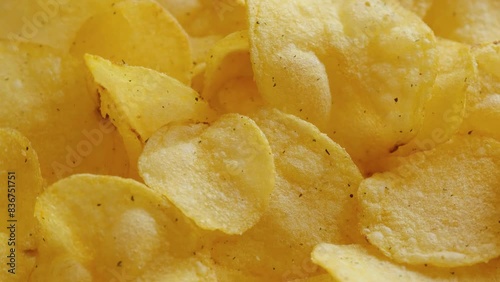 Crispy potato chips rotating close-up. Golden fried potatoes, top view