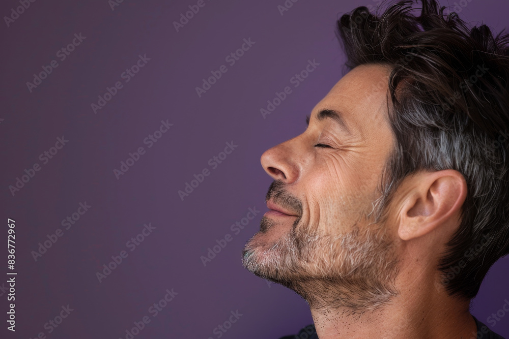 Fototapeta premium A close up of a man with beard and closed eyes looking to a side