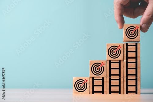 Φωτογραφία Hand put dartboard with arrow on the top of ladder for enhance and achievement setup business objective target goal concept