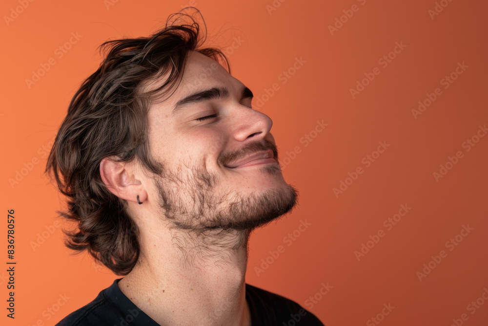 Fototapeta premium A close up of a man with beard and closed eyes looking to a side