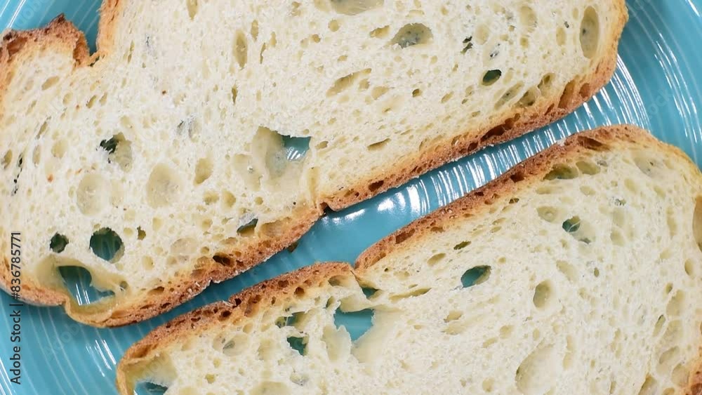Slices of Italian rustic soft wheat bread from Lazio region.Fette di pane rustico di grano tenero Italiano della regione Lazio.Close-up,rotating video.