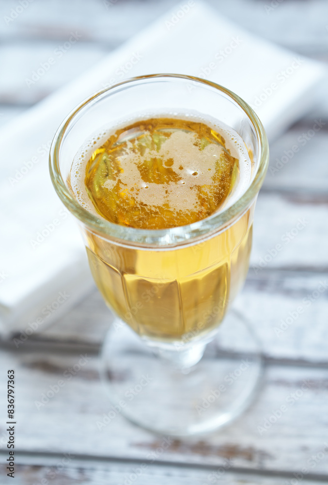 Glass of beer on bright wooden background. Copy space. Glass of beer on bright wooden background. Copy space.