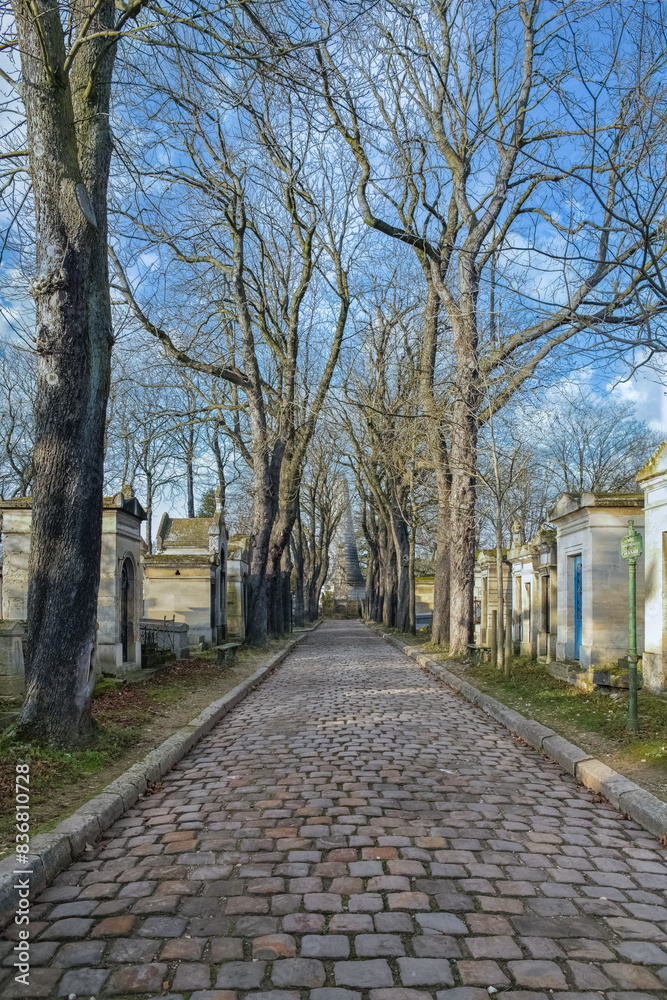 Paris, the Pere-Lachaise cemetery, cobbled alley with graves 
