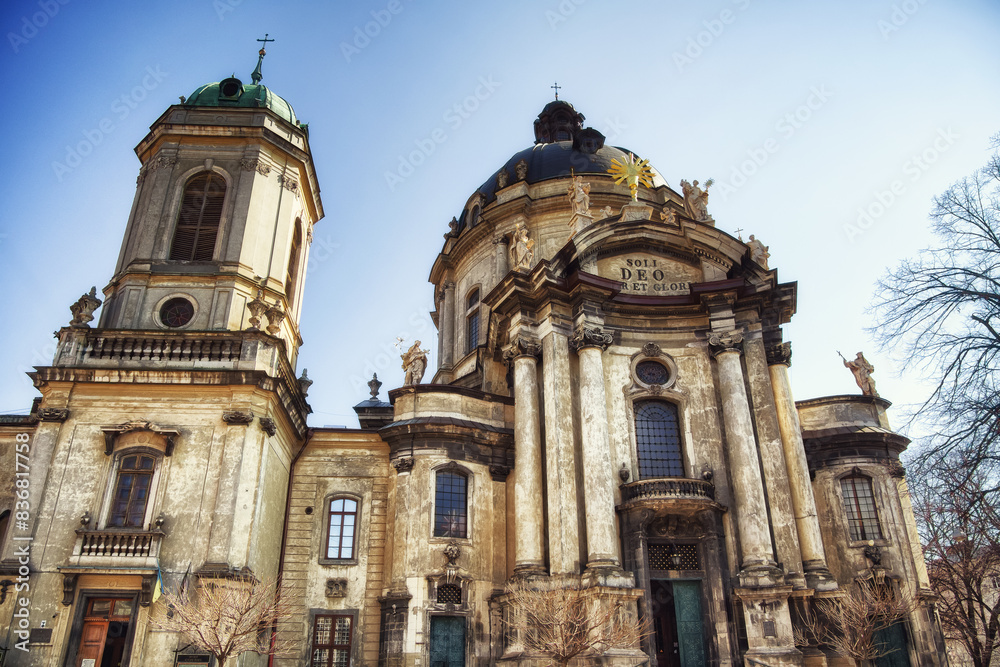 Sunlit Devotion: Facade of an ancient church with artistic stonework, representing worship. The Dominican church and monastery Sunlit Devotion: Facade of an ancient church with artistic stonework, representing worship. The Dominican church and monastery