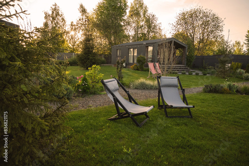 Barnhouse, Barn house. Wooden secluded house in the Scandinavian and Finland modern style with beautiful green garden with sun loungers for relaxation.