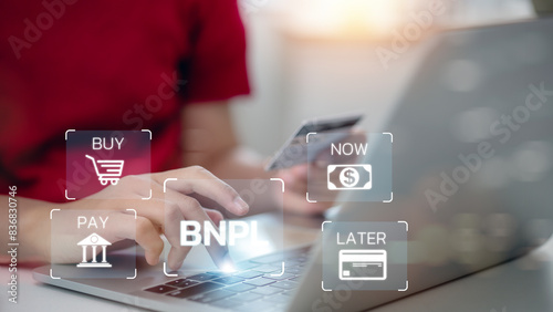 Women use laptops and credit cards with icons of BNPL with online shopping icons technology. BNPL Buy now pays later online shopping concept.