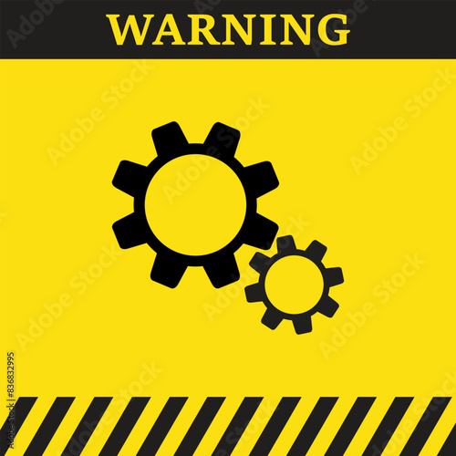 Warning symbol on yellow background with silhouette of rotating gear 