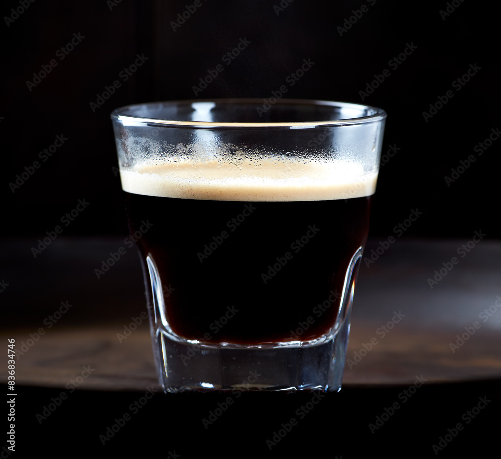 Coffee in glass cup on dark background. Close up. Copy space Coffee in glass cup on dark background. Close up. Copy space