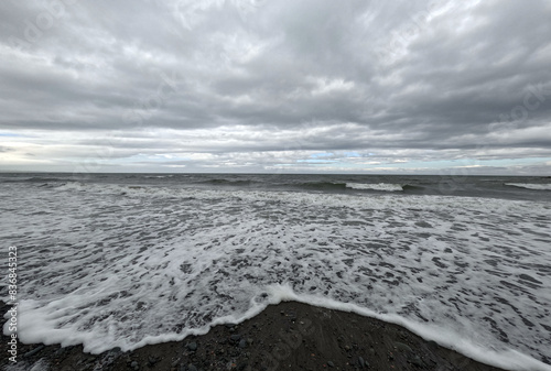 Rocky beach under cloudy sky with scattered leaves in Ballantrae, Ayrshire, Scotland, UK photo