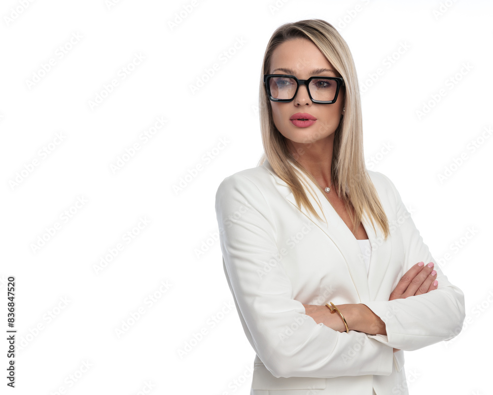 curious businesswoman looking to side while holding hands folded curious businesswoman looking to side while holding hands folded