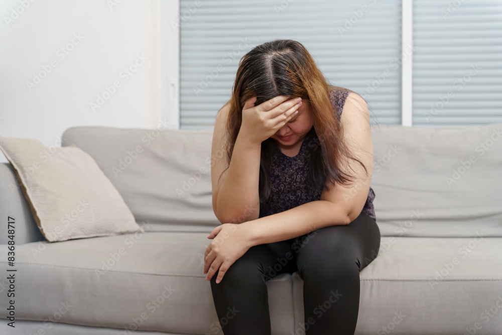 Sad Overweight plus size woman thinking about problems on sofa upset girl feeling lonely and sad from bad relationship or Depressed woman disorder mental health Sad Overweight plus size woman thinking about problems on sofa upset girl feeling lonely and sad from bad relationship or Depressed woman disorder mental health