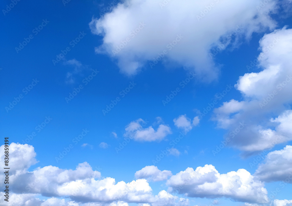 Clear blue sky texture and white fluffy cloud nature background. The sun shines bright in the daytime in summer Clear blue sky texture and white fluffy cloud nature background. The sun shines bright in the daytime in summer