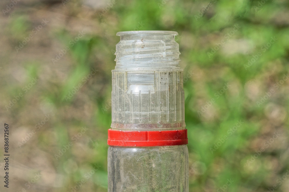 Fototapeta premium part one of white open glass bottle on a green background