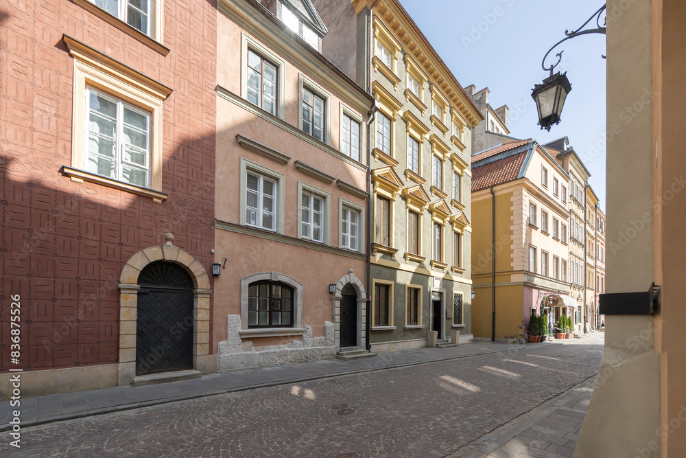 A vibrant historic street in the old town, featuring colorful buildings with arched doorways and cobblestone paths. The charming urban scene showcases classic European architecture. A vibrant historic street in the old town, featuring colorful buildings with arched doorways and cobblestone paths. The charming urban scene showcases classic European architecture.