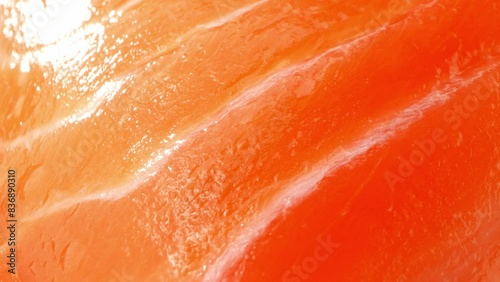 Premium salmon slices showcase vibrant layers of muscle tissue intertwined with delicate intramuscular fat, exuding freshness. Astaxanthin lends a rich orange hue, elevating its visual allure.
 photo