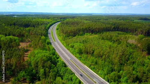 Aerial view of a highway going through the forest. D5 highway in Czech republic, European union. Beautiful forest with highway from drone view.