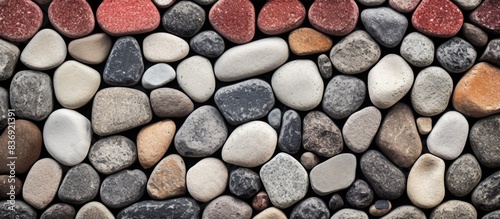 Ancient cobblestone pathway with a mix of red, gray, and white stones creating a textured backdrop for a copy space image.
