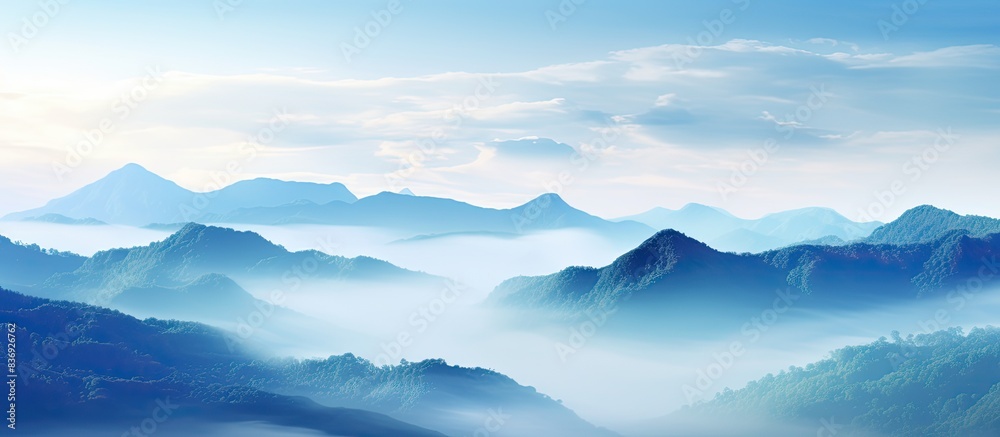 Enjoy the breathtaking view of misty mountains in this picturesque landscape with a captivating copy space image.