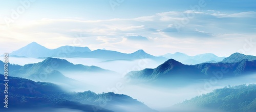 Enjoy the breathtaking view of misty mountains in this picturesque landscape with a captivating copy space image.