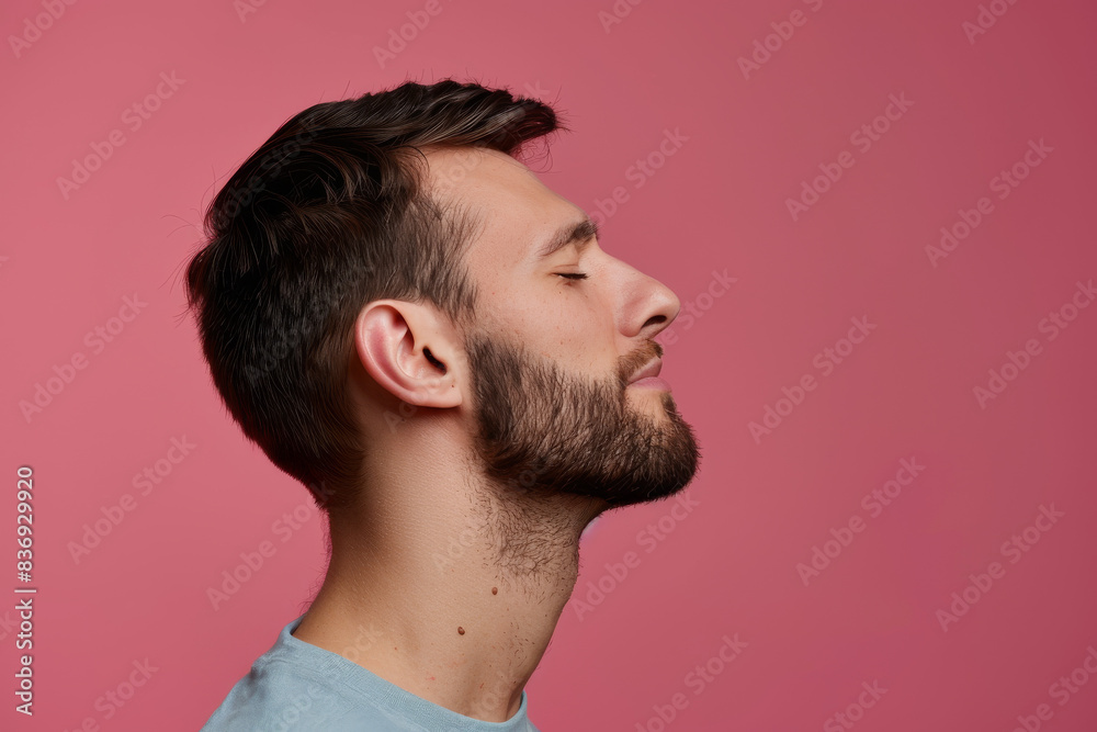 Fototapeta premium A close up of a man with beard and closed eyes looking to a side