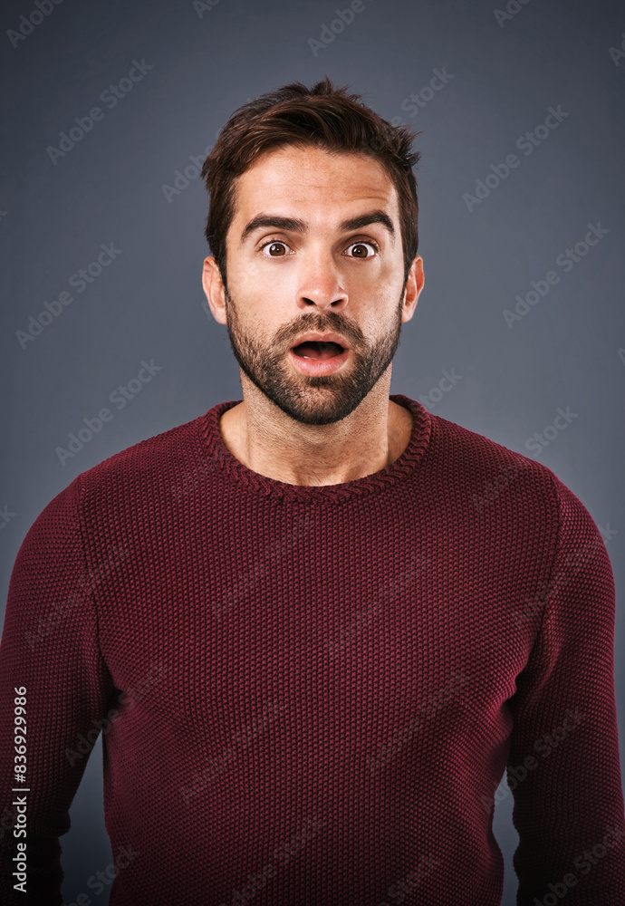 Studio, surprise and man with news, portrait and gossip of discount, wow and rumor in mockup space. Gray background, face and person with shock, secret and fear for phobia and scared with alert Studio, surprise and man with news, portrait and gossip of discount, wow and rumor in mockup space. Gray background, face and person with shock, secret and fear for phobia and scared with alert