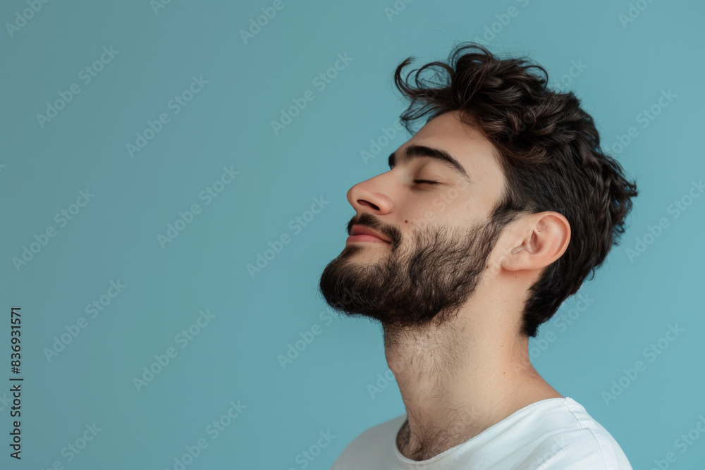 Fototapeta premium A close up of a man with beard and closed eyes looking to a side