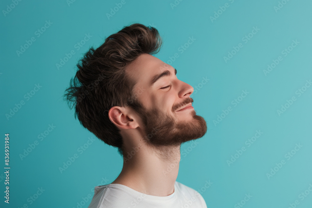 A close up of a man with beard and closed eyes looking to a side A close up of a man with beard and closed eyes looking to a side
