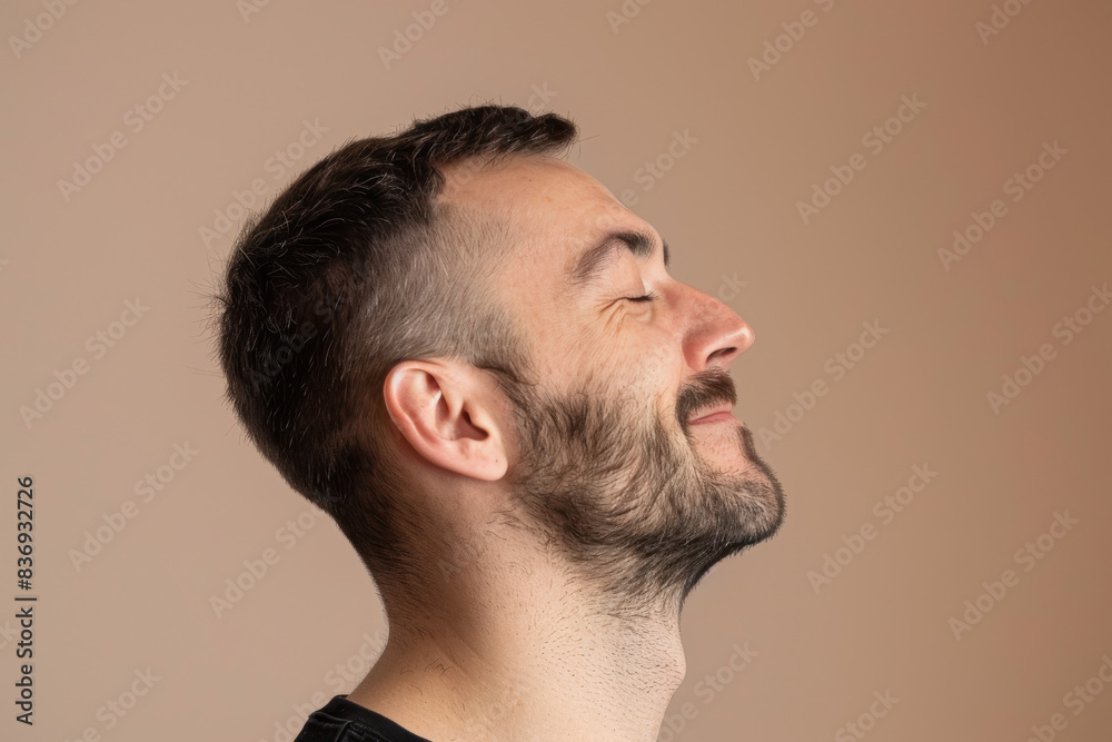 Fototapeta premium A close up of a man with beard and closed eyes looking to a side