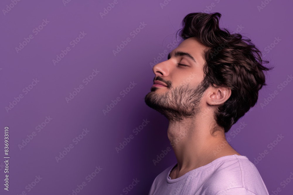 A close up of a man with beard and closed eyes looking to a side A close up of a man with beard and closed eyes looking to a side