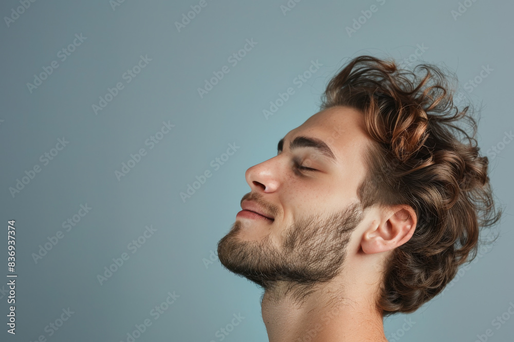 Fototapeta premium A close up of a man with beard and closed eyes looking to a side