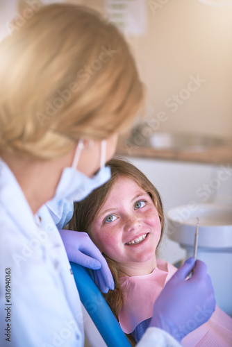 Dentist, kid and doctor talking for teeth cleaning or cavity treatment for oral hygiene or dental health. Paediatric clinic, advice and happy girl child with woman and smile for medical consultation