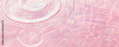 Pink liquid top view. Water surface with gentle ripples and concentric rings, capturing the serene and refreshing essence of calm water