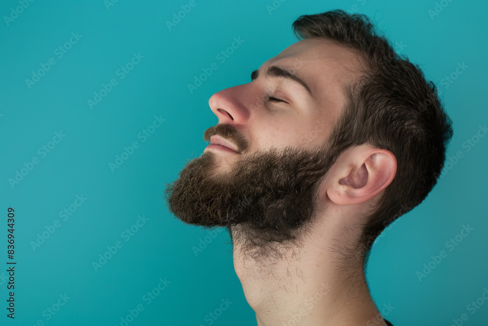 Fototapeta premium A close up of a man with beard and closed eyes looking to a side