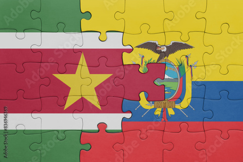 puzzle with the colourful national flag of ecuador and flag of suriname